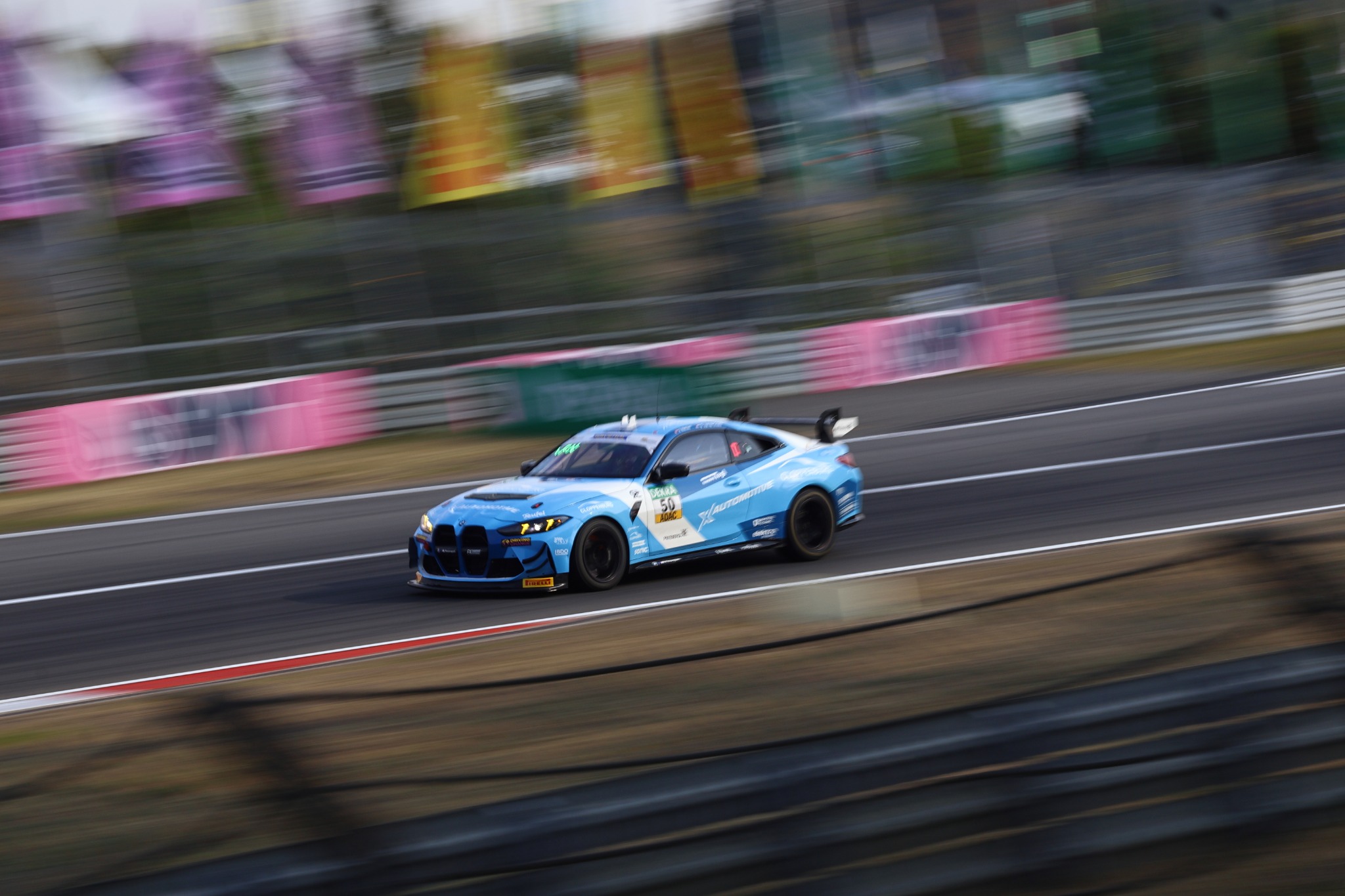 Blue BMW race car in motion